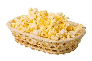 Popcorn in a basket on white background photo