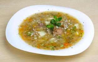 Cereal soup on the plate and wooden background photo