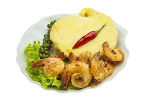 Garlic shrimps with potato on the plate and white background photo