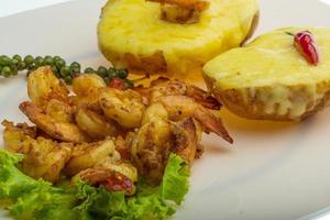 Garlic shrimps with potato close up view photo