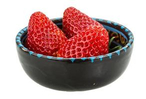 Strawberry in a bowl on white background photo