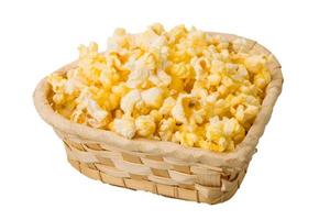 Popcorn in a basket on white background photo