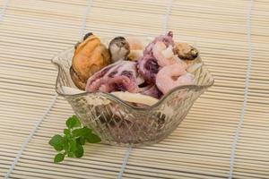 Seafood cocktail on wooden background photo