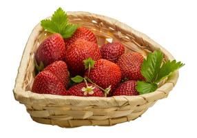 Ripe strawberry in a basket on white background photo