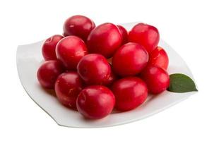 Damson plum on the plate and white background photo