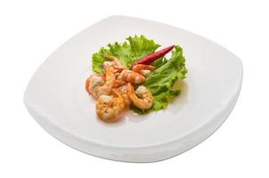 Unshelled king prawn on the plate and white background photo