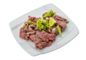 Beef carpaccio on the plate and white background photo