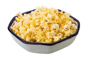 Popcorn in a bowl on white background photo