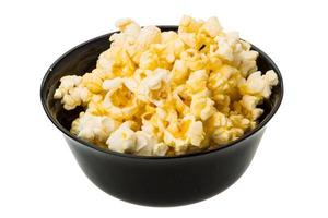 Popcorn in a bowl on white background photo