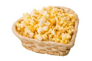 Popcorn in a basket on white background photo