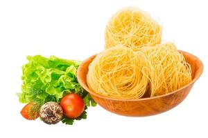 Tagliatelle in a bowl on white background photo