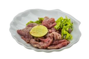 Beef carpaccio on the plate and white background photo