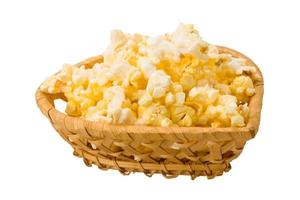 Popcorn in a basket on white background photo