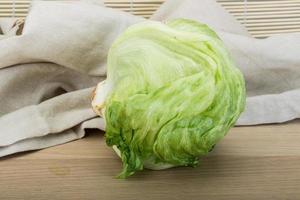 iceberg salad on wooden background photo