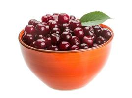 Cherry in a bowl on white background photo