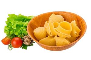 Raw pasta in a bowl on white background photo