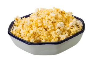 Popcorn in a bowl on white background photo