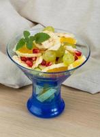 Fruit salad on wooden plate photo