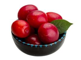 Damson plum in a bowl on white background photo