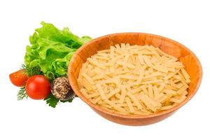 Raw pasta in a bowl on white background photo