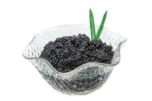 Black caviar in a bowl on white background photo