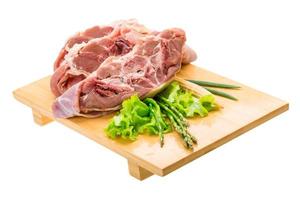 Raw lamb on wooden board and white background photo
