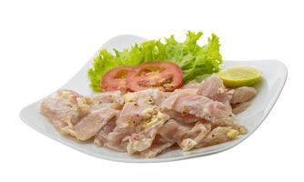 Swordfish carpaccio on the plate and white background photo