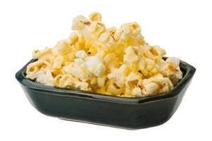 Popcorn in a bowl on white background photo