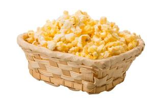 Popcorn in a basket on white background photo