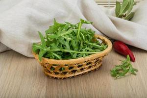 Ruccola on wooden background photo