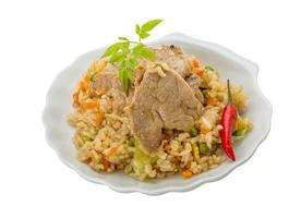 Fried rice with pork on the plate and white background photo