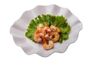 Unshelled king prawn on the plate and white background photo