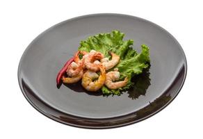 Unshelled king prawn on the plate and white background photo