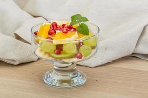 Fruit salad on wooden background photo