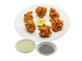 Onion bhajee on the plate and white background photo