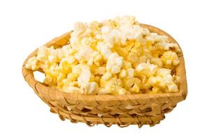 Popcorn in a basket on white background photo