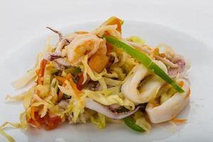 Asian seafood salad on the plate photo