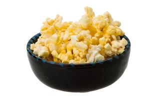 Popcorn in a bowl on white background photo