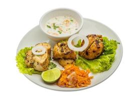 Chicken Tikka on the plate and white background photo