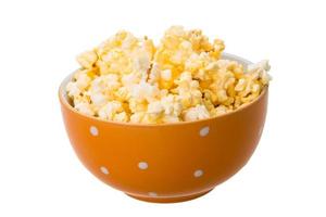 Popcorn in a bowl on white background photo