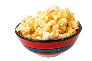 Popcorn in a bowl on white background photo