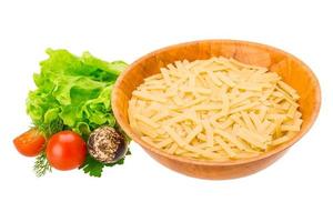 Raw pasta in a bowl on white background photo