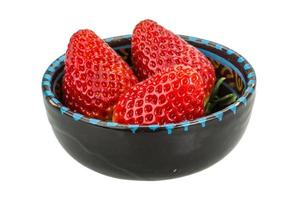 Strawberry in a bowl on white background photo