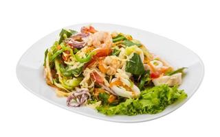 Asian seafood salad on the plate and white background photo