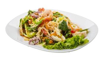 Asian seafood salad on the plate and white background photo