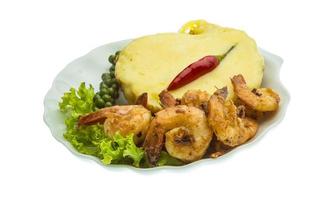 Garlic shrimps with potato on the plate and white background photo