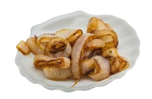 Fried onion on the plate and white background photo