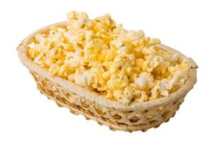 Popcorn in a basket on white background photo