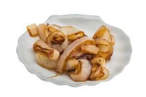 Fried onion on the plate and white background photo