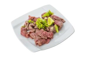 Beef carpaccio on the plate and white background photo